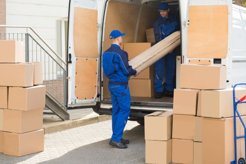 Removal team planning a house move in Merton with boxes and furniture