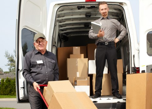 Local movers loading a van on a Merton residential street