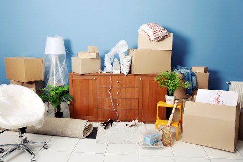 Furniture being carried through a shared entrance for a flat move