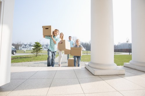 Household removal service handling furniture and boxes in a Merton property
